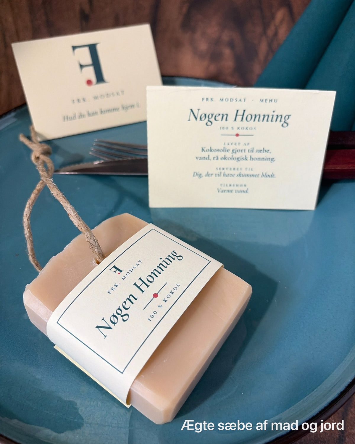 Nøgen Honning med hampesnor, serveret med menukort, kniv og gaffel